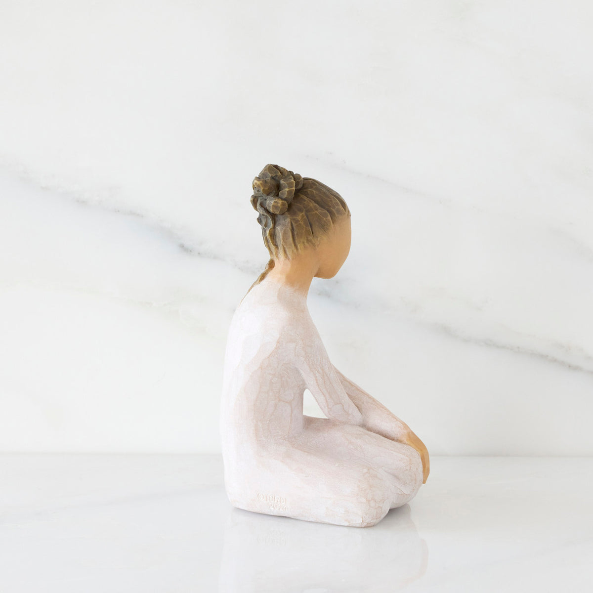 Right-facing view: seated figure in cream dress with crossed arms